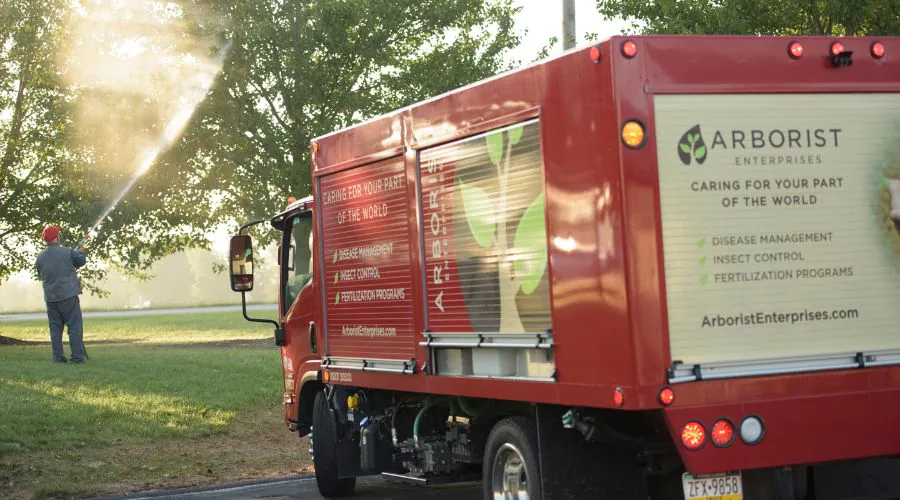 A member of the team at Arborist Enterprises spraying a tree for insects in Lititz, PA