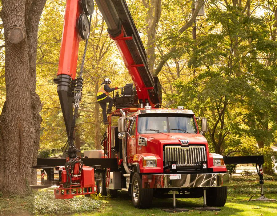 Arborist Enterprises Red truck with a grappler.