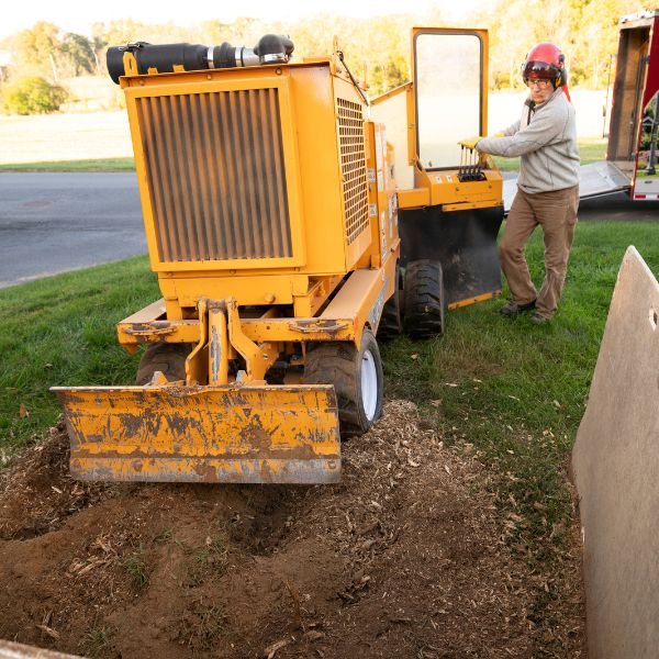 Arborist Enterprises crew member operating the stump grinder.